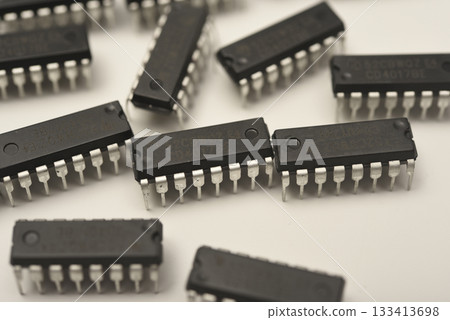 Microchips in a DIP case on a white background. A microelectronic element. Black microchips. Microchips in a DIP case on a white background. A microelectronic element. Black microchips. 133413698