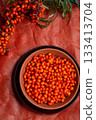 ripe sea buckthorn berries with  branch on wooden table. flat lay 133413704