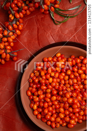 ripe sea buckthorn berries with  branch on wooden table. flat lay 133413705