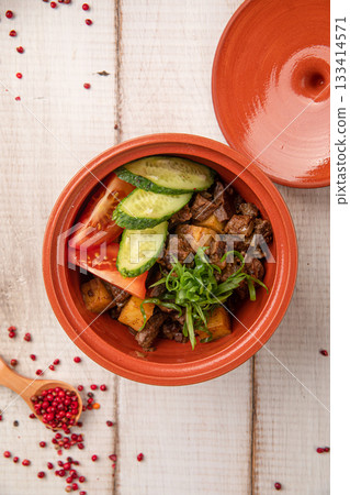 Rustic clay pot with stewed meat potatoes vegetables 133414571