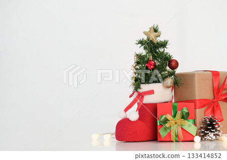 Christmas decorations with gifts and a mini tree on a white background Christmas decorations with gifts and a mini tree on a white background 133414852