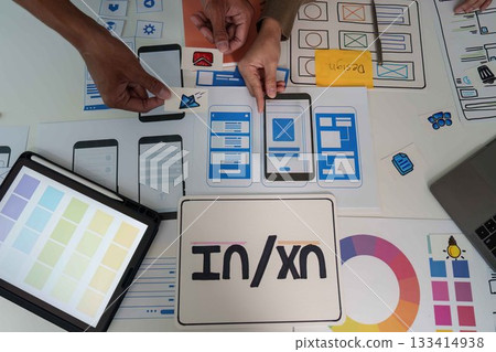 UI UX Design Collaboration. Team brainstorming and creating mobile app prototypes. UI UX Design Collaboration. Team brainstorming and creating mobile app prototypes. 133414938