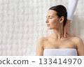 Young woman receiving gentle shoulder massage at spa center 133414970