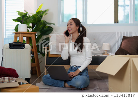 Remote Work: Young Woman on Phone While Setting Up New Home Office 133415017