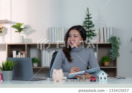 Positive Financial Outlook. Woman smiling while reviewing financial plans. 133415057