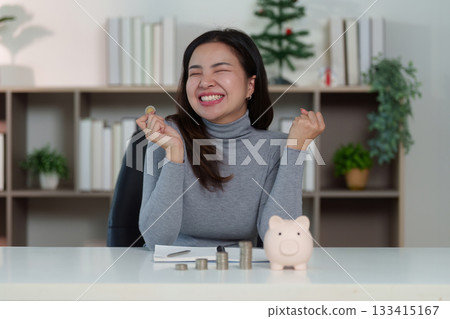 Joyful Savings: Woman Celebrating Financial Success with Coins Joyful Savings: Woman Celebrating Financial Success with Coins 133415167