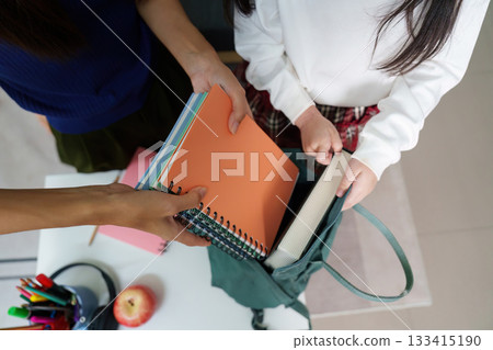 Hands Sharing Notebooks for School with Apple in View 133415190