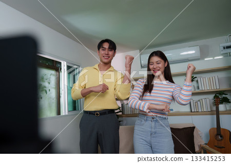Energetic young couple dancing together during video call Energetic young couple dancing together during video call 133415253