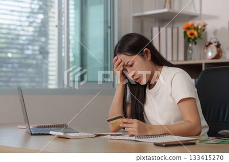 Worry. Woman feeling anxious about credit card bills at home office. Worry. Woman feeling anxious about credit card bills at home office. 133415270