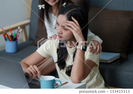 Stressful Study Session. Young woman feeling overwhelmed while studying at home. 133415313