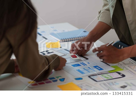 Hands Collaborating on UX UI Design Prototypes 133415331