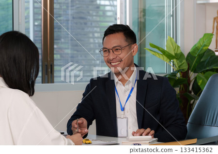 Smiling Insurance Agent Engaging with Client Smiling Insurance Agent Engaging with Client 133415362