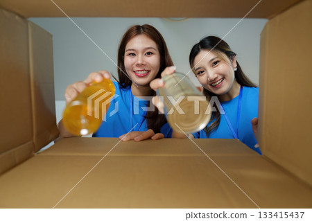 Volunteers preparing food donations for local community 133415437