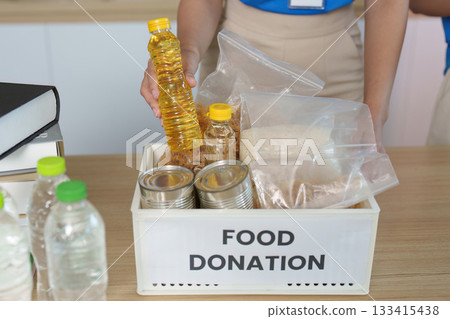 Food Donation Initiative. Volunteers organizing food items for community support. Food Donation Initiative. Volunteers organizing food items for community support. 133415438
