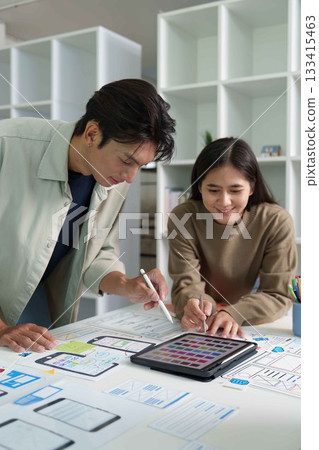 Creative Teamwork. Young designers collaborating on digital mockups and color selections. 133415463