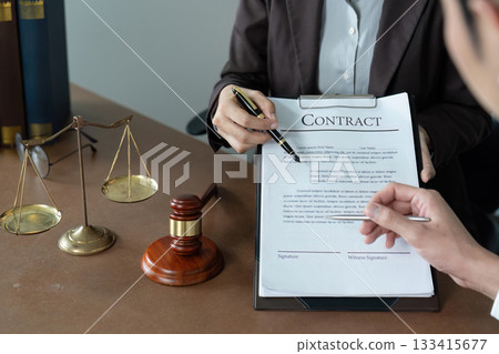 Contract Review. Lawyer explaining legal terms to client in office. Contract Review. Lawyer explaining legal terms to client in office. 133415677