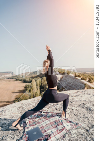 Yoga on the Cliffside: Woman Practicing Warrior Pose with a View 133415893