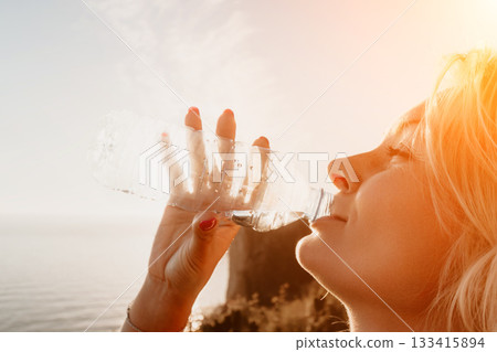 Woman Refreshing with Water on a Sunny Day 133415894