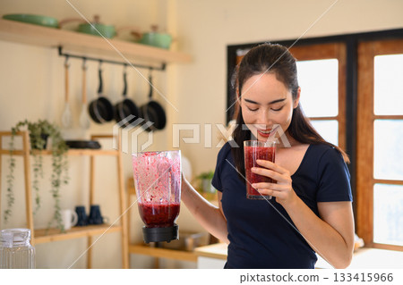 Photo set of a woman making a fruit smoothie in her home kitchen, reflecting a healthy and balanced daily lifestyle 133415966