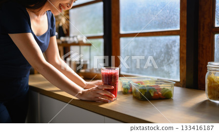 Photo set of a woman making a fruit smoothie in her home kitchen, reflecting a healthy and balanced daily lifestyle Photo set of a woman making a fruit smoothie in her home kitchen, reflecting a healthy and balanced daily lifestyle 133416187