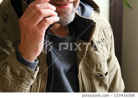 Man Talking on Smartphone Indoors 133416306
