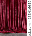Closed red velvet stage curtain with soft spotlight 133416659