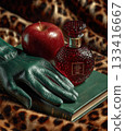 Perfume bottle green gloves and apple on leopard print 133416667