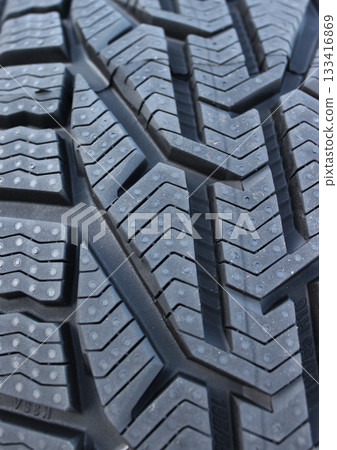 Close Up Photo of New Car Tire Surface with Aggressive Protector Design. Details of Tire Tread Pattern Vertical Photo  133416869