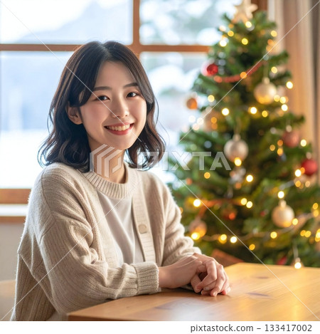 A woman smiling gently in the soft winter light with a Christmas tree in the background A woman smiling gently in the soft winter light with a Christmas tree in the background 133417002
