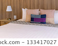 Luxurious Bedroom with Comfortable Bed, Stylish Furniture, and Soft Pillows in a Cozy Home Setting 133417027