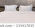 Cozy Hotel Room Interior with a large bed and clean white pillows 133417035
