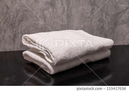 A clean stack of white folded towels in the bathroom A clean stack of white folded towels in the bathroom 133417036