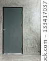 Interior entrance to a room with a closed door and bare concrete wall surface 133417037