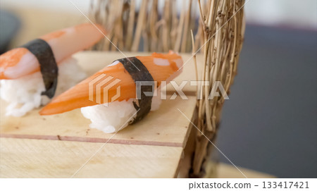 Crab sushi, traditional Japanese food style. Sliced crab stick on rice display for photo shooting. Crab sushi, traditional Japanese food style. Sliced crab stick on rice display for photo shooting. 133417421