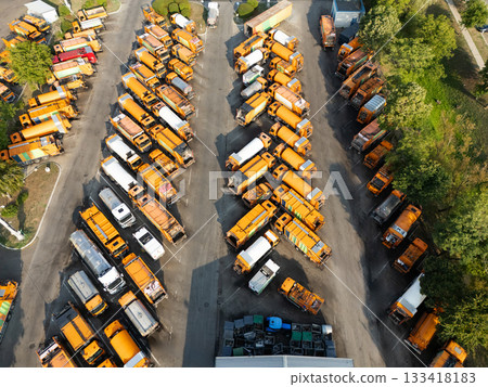 Fleet of yellow garbage trucks. Aerial view. Fleet of yellow garbage trucks. Aerial view. 133418183