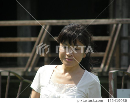 Woman standing in front of a hut Woman standing in front of a hut 133419086
