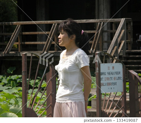 Woman standing in front of a hut Woman standing in front of a hut 133419087