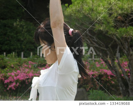 Woman standing in front of a hut Woman standing in front of a hut 133419088