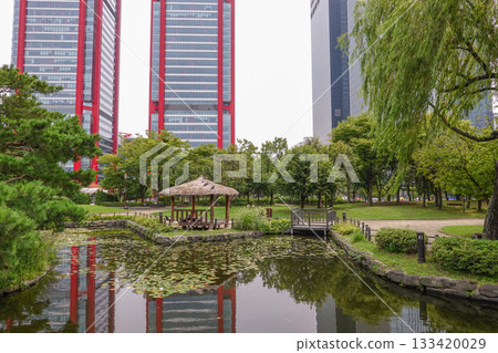 Tranquil Gazebo Surrounded by Greenery and Urban Skyscrapers Reflected in the Pond at Yeouido Park Seoul Tranquil Gazebo Surrounded by Greenery and Urban Skyscrapers Reflected in the Pond at Yeouido Park Seoul 133420029