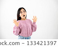 Young woman making a surprised gesture on white background 133421397