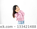 Young woman making cheek heart pose on white background 133421488
