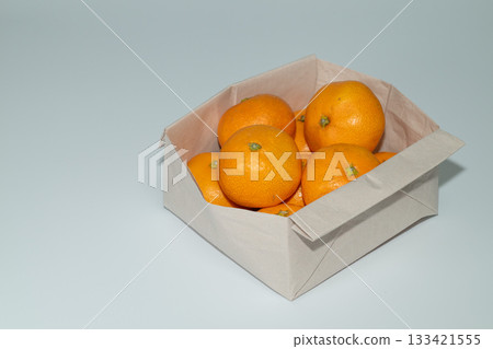一袋裝著新鮮橘子的紙袋,留有文字空間。 一袋裝著新鮮橘子的紙袋,留有文字空間。 133421555