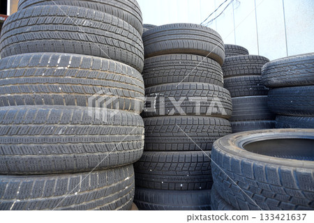 A pile of worn, slip-resistant, cracked discarded tires A pile of worn, slip-resistant, cracked discarded tires 133421637