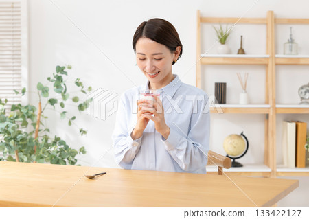Woman eating yogurt Woman eating yogurt 133422127