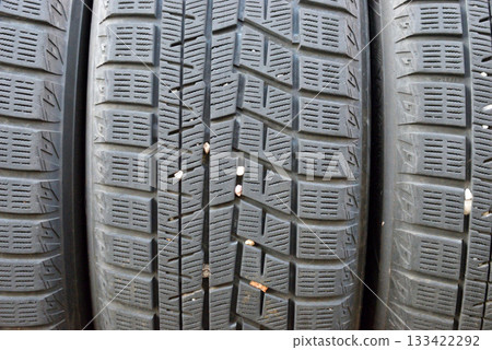 Discarded tires with pebbles stuck in them Discarded tires with pebbles stuck in them 133422292