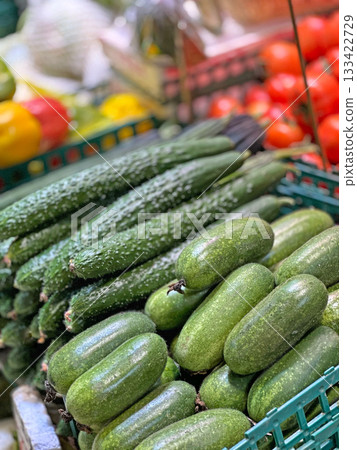 These green cucumbers are ready to be purchased and enjoyed as a healthy snack or ingredient in a meal These green cucumbers are ready to be purchased and enjoyed as a healthy snack or ingredient in a meal 133422729