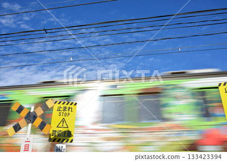 Blue sky and cross mark, stop, caution at railroad crossing and train 133423394