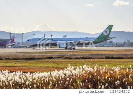 Sendai Airport at dusk, plane taxiing, Natori City, Miyagi Prefecture 133424392