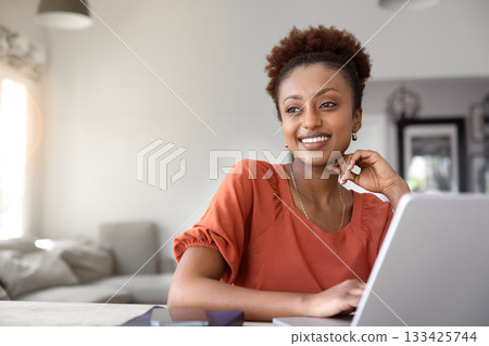 Positive Black freelancer woman enjoying remote work at laptop 133425744