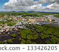 Coastal town with houses and boats surrounded by mangrove forest and water. Siargao, Philippines. 133426205